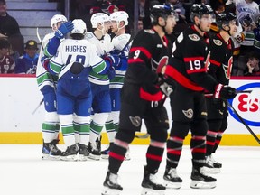 The Vancouver Canucks celebrate a goal while taking on the Ottawa Senators.