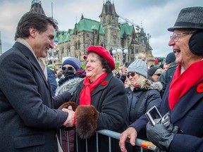 Ellen Marie Vanneste greets Prime Minister Justin Trudeau following Remembrance Day