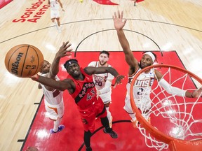 Pascal Siakam of the Toronto Raptors goes to the basket as a trio of Phoenix Suns defend.