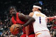 Toronto Raptors' Pascal Siakam (43) tries to get around Phoenix Suns' Devin Booker (1) during first half NBA basketball action in Toronto on Wednesday, November 29, 2023.