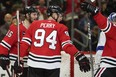 Chicago Blackhawks right winger Corey Perry celebrates with teammates.