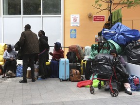 Some of the asylum-seeking refugees that have come to Canada from African nations like Uganda, Kenya, Nigeria and Tanzania are camped out outside the Peter St. city-run shelter for the homeless -- some for two weeks sleeping on the sidewalks -- on Thursday, July 13, 2023.