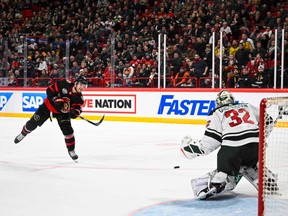 Forward Josh Norris of Ottawa Senators (L) shoots to score past goaltender Filip Gustavsson