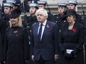 From left, former British Prime Ministers Liz Truss, Boris Johnson and Theresa May attend the annual Remembrance Sunday ceremony at the Cenotaph in London, Sunday, Nov. 12, 2023.