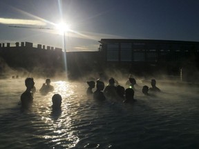 People relax in the Blue Lagoon, a geothermal spa that's the most visited attraction in the country, in Grindavik, Iceland, April 27, 2016.