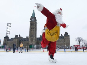 Postmedia reporter Bruce Deachman goes for a skate, while dressed as Santa, on Parliament Hill in Ottawa Thursday Dec 7, 2017.