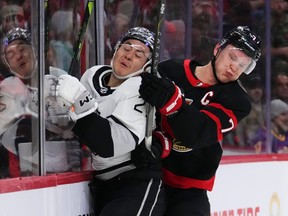 Ottawa Senators left wing Brady Tkachuk hits Los Angeles Kings defenceman Jordan Spence into the boards during first-period action at the Canadian Tire Centre on Thursday, Nov. 2, 2023.