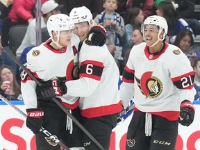 The Ottawa Senators' Jakob Chychrun, centre, celebrates with Tim Stutzle, left, and Mathieu Joseph after scoring against the Toronto Maple Leafs during the second period in Toronto on Wednesday, Nov. 8, 2023.