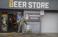 A patron returns beer cans at a Beer Store location in Toronto.