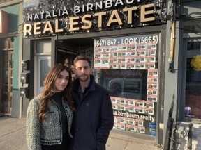 Natalia and Moshe Birnbaum have the posters of all 240 hostages on the front of their storefront business and say they will stay there until Hamas releases them -- Joe Warmington photo