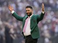 Golfer, Jon Rahm throws out the ceremonial first pitch before Game 4 of the baseball World Series between the Arizona Diamondbacks and the Texas Rangers Tuesday, Oct. 31, 2023, in Phoenix.