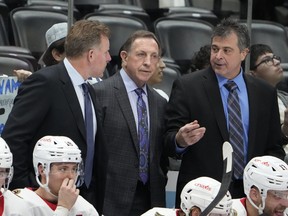 Ottawa Senators interim coach Jacques Martin (centre) listens to assistant coaches Daniel Alfredsson, left, and Jack Capuano.