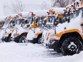 File photo: School buses sit idle following a storm earlier this year. School bus service in Ottawa and Eastern Ontario was cancelled Monday.