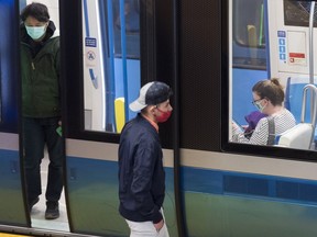FILE PHOTO: People wear face masks as they commute via metro in Montreal.