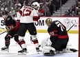 The puck bounces by the skate of New Jersey Devils centre Nico Hischier as Ottawa Senators goaltender Joonas Korpisalo makes a save