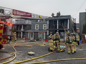 Firefighters work at the scene of a fire on St. Patrick Street