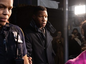 Jonathan Majors (centre) leaves a courtroom after being found guilty of assault and harassment of his former girlfriend, at the Manhattan criminal courts in New York City on Dec. 18, 2023.