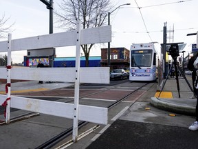 The Tacoma Link Light Rail is blocked during a rally after the verdict is read during the trial of three Tacoma Police officers in the killing of Manny Ellis, at Pierce County Superior Court, Thursday, Dec. 21, 2023, in Tacoma, Wash.