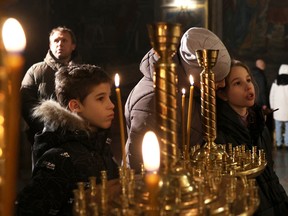 Worshippers attend an Orthodox Christmas service at the Saint Michael's Golden-Domed Monastery in Kyiv, on December 24, 2023.