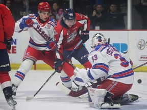 Tomas Hamara, left, of the Kitchener Rangers tangles with Jacob Maillet of the Windsor Spitfires.