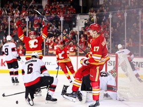 Yegor Sharangovich of the Calgary Flames celebrates his third-period goal on Joonas Korpisalo of the Ottawa Senators.