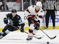 Ottawa Senators defenceman Thomas Chabot works to control the puck against the Seattle Kraken.