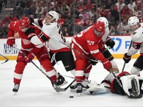 Ottawa Senators winger Mathieu Joseph hits Detroit Red Wings center Dylan Larkin during a game.