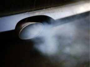 A file photo shows gases pouring out of an exhaust pipe.