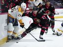 Senators centre Shane Pinto (57) pushes Nashville Predators centre Philip Tomasino (26) off the puck during first period NHL hockey action in Ottawa on Monday. 
