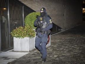 A Danish police stands before the court in Frederiksberg for the constitutional hearing, Thursday Dec. 14, 2023.