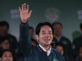 Taiwanese Vice President Lai Ching-te, also known as William Lai, left, celebrates his victory in New Taipei City, Taiwan, Saturday, Jan. 13, 2024. The Ruling-party candidate emerged victorious in Taiwan's presidential election on Saturday and his opponents conceded, a result that will chart the trajectory of the self-ruled democracy's relations with China over the next four years.