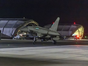 In this image provided on Friday Jan. 12, 2024 by the U.K. Ministry of Defence an RAF Typhoon aircraft returns to base at RAF Akrotiri in Cyprus, after striking targets in Yemen.