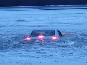 A bystander helped the driver of this vehicle back to shore on the Ottawa River Saturday. The car was apparently driven onto the ice, then broke through.