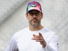 New York Jets quarterback Aaron Rodgers walks on the field before an NFL football game against the Philadelphia Eagles, Sunday, Oct. 15, 2023, in East Rutherford, N.J.