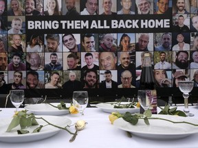 Pictures of the hostages kidnapped during the Oct. 7 Hamas cross-border attack in Israel are placed by a table set during a protest outside the International Court of Justice in The Hague, Netherlands, Friday, Jan. 12, 2024.