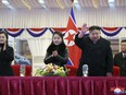 In this photo provided by the North Korean government, leader Kim Jong Un, second right, with his daughter and his wife Ri Sol Ju, left, attends a performance to celebrate the New Year in Pyongyang, North Korea, Sunday, Dec. 31, 2023.