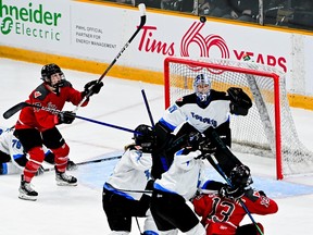 Toronto goalie Erica Howe looks towards a floating puck as Ottawa forward Gabbie Hughes (17) attempts to gain possession during the second period.