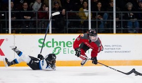 Toronto defender Allie Munroe falls to the ice as Ottawa forward Hayley Scamurra attempts to regain possession of the puck during the first period at TD Place Arena on Tuesday, Jan. 23, 2024.