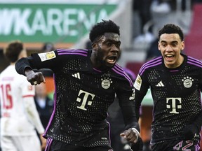 Bayern Munich's Alphonso Davies (left) celebrates scoring with teammate Jamal Musiala.