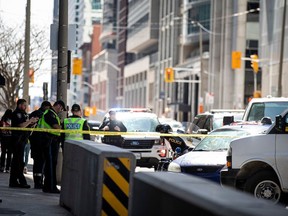 Police vehicles surround a car on Queen Street in Ottawa