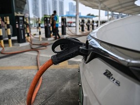This picture taken on October 18, 2023 shows an electric vehicle being charged at Antuoshan charging station in Shenzhen, China's southern Guangdong province.