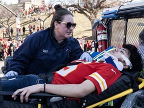An injured person is aided near the Kansas City Chiefs' Super Bowl LVIII victory parade on February 14, 2024 in Kansas City, Missouri. One person was killed and at least 21 people were injured, among them several children, in a shooting Wednesday at a parade celebrating the Kansas City Chiefs' Super Bowl victory, police said.