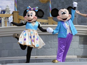 Minnie and Mickey Mouse perform for guests during a musical show in the Magic Kingdom at Walt Disney World, July 14, 2023, in Lake Buena Vista, Fla.