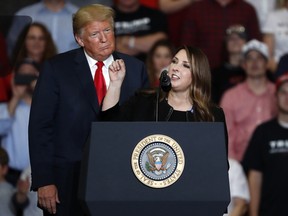 President Donald Trump listens as Republican National Committee chair Ronna McDaniel, right, speaks during a campaign rally Nov. 5, 2018, in Cape Girardeau, Mo.