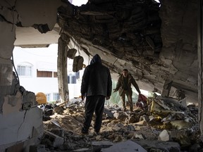 Palestinians check destruction after an Israeli strike in Rafah, Gaza Strip, Saturday, Feb.10, 2024.