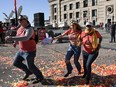 People flee after shots were fired near the Kansas City Chiefs' Super Bowl LVIII victory parade on February 14, 2024, in Kansas City, Missouri.