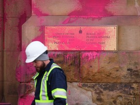 Pink paint covers a sign on the entrance to the prime minister's office on Wellington Street in Ottawa on Wednesday, Feb.7, 2024.