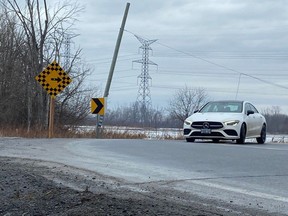 A driver negotiates one of two sharp curves on Renaud Road on Wednesday, Feb. 28, 2024. The city and the NCC have reached an agreement that would eliminate the hazardous stretch of road by extending Brian Coburn Boulevard across the NCC Greenbelt, north of the Mer Bleue Bog.