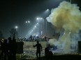 Farmers disperse after police fired tear gas during a protest demanding minimum crop prices, at Shambhu Haryana-Punjab border on February 13, 2024.