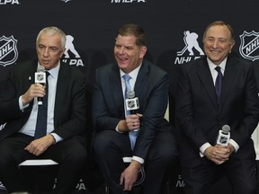 IIHF President Luc Tarif, NHLPA executive director Marty Walsh and NHL commissioner Gary Bettman speak with the media on February 2, 2024 at the Scotiabank Arena in Toronto.